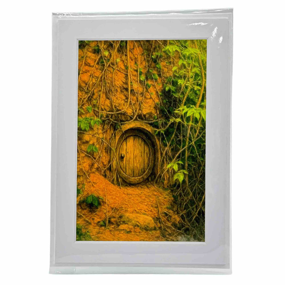 A greeting card with a mossy wooden door built into the side of a rocky Ozark hill in Eureka Springs Arkansas
