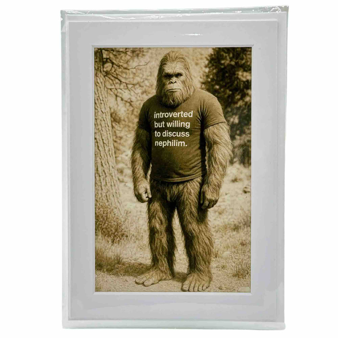 A greeting card with Bigfoot standing confidently in the woods of Eureka Springs Arkansas under a dramatic sky, with surreal light effects.
