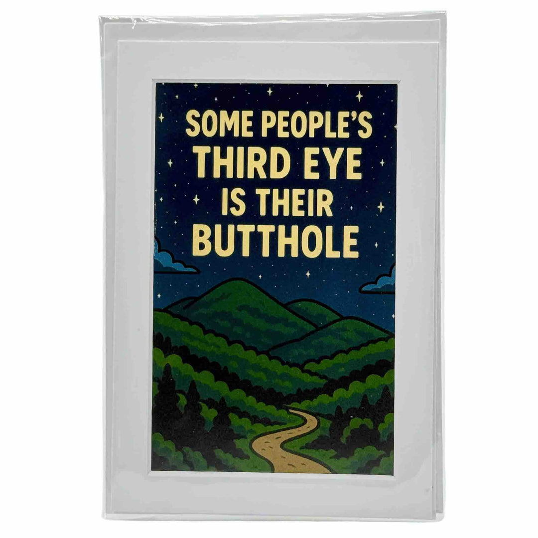 A greeting card with a bold brown eye with a third eye above it, surrounded by mystical symbols