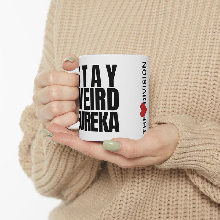 Stay Weird Eureka Mug being held