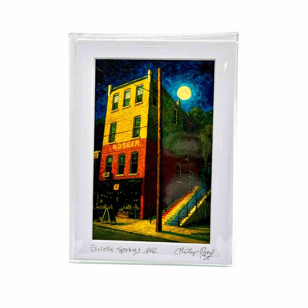 Greeting card art print of the rainbow stairs on a full moon winter night in Eureka Springs AR hillside under the moonlight, with layered trees and a dreamy, vertical perspective.

