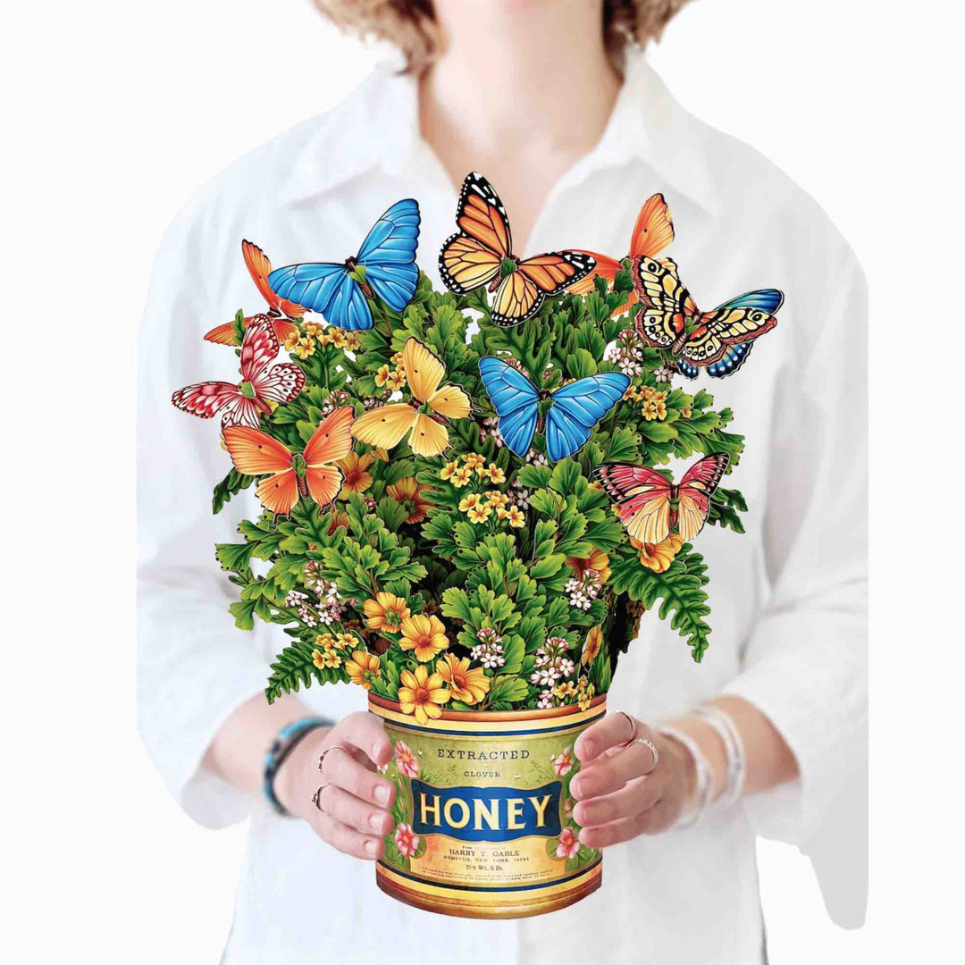 Bright yellow buttercups with floating butterflies in a joyful pop-up card design.